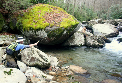 Angler kneeling to fish