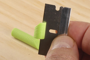 This photograph shows the depth of the razor blade in the popper body.